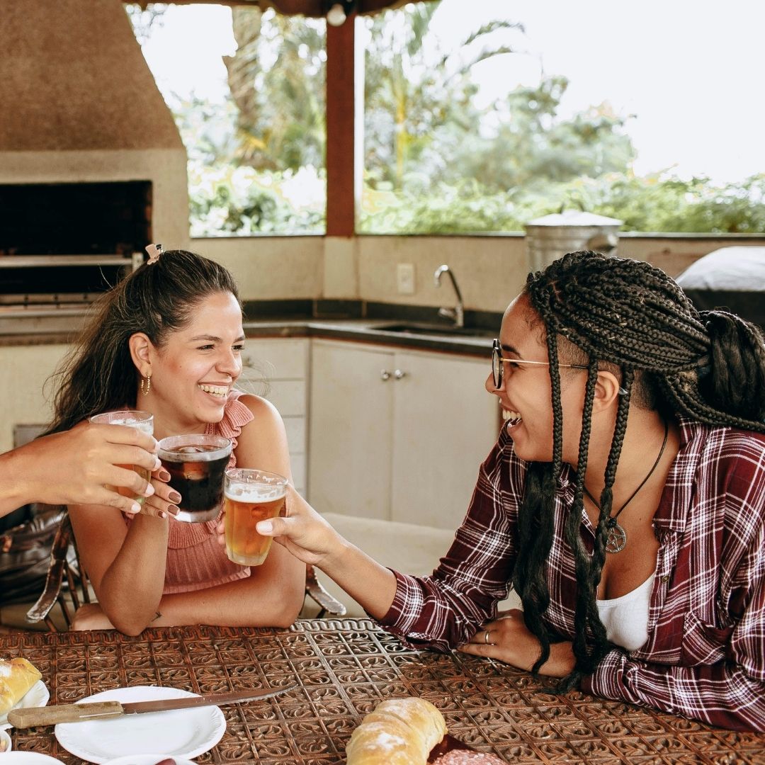 friends sitting near an outdoor kitchen